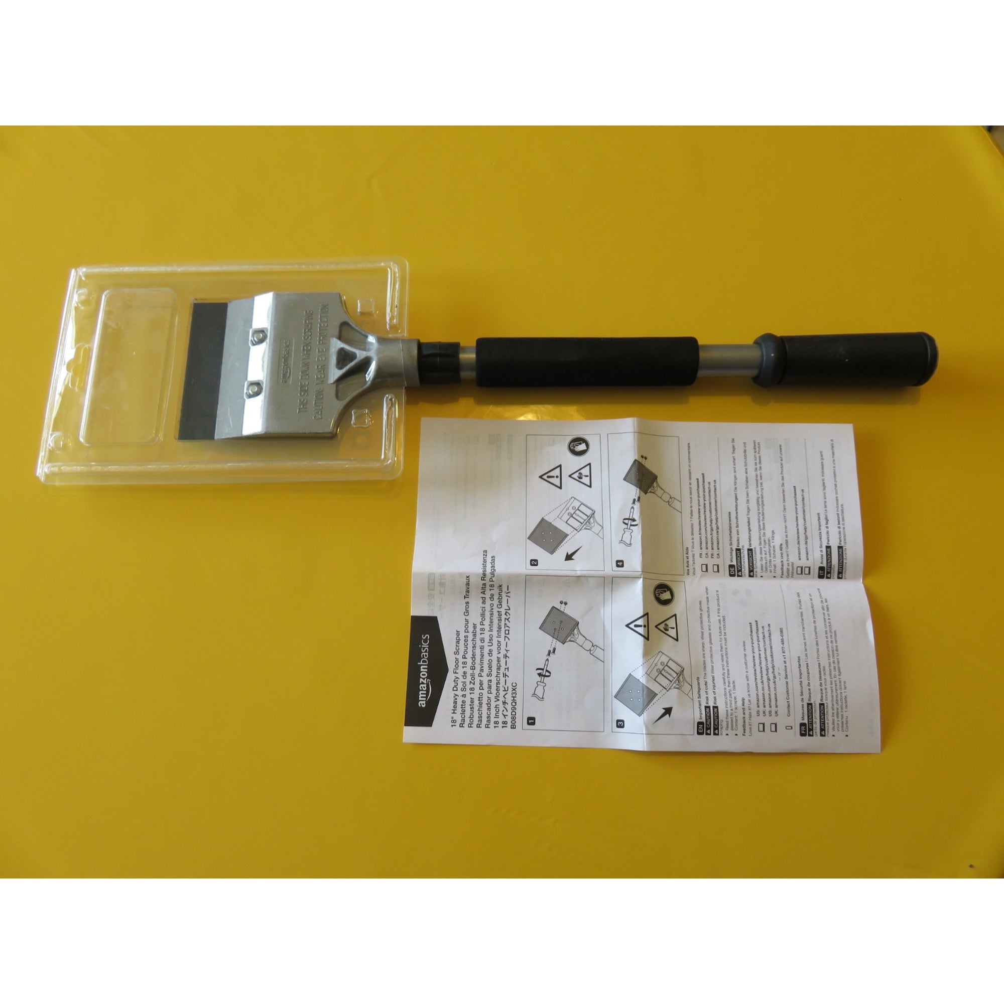 18-inch Amazon floor scraper tool with metal blade and ergonomic handle for heavy-duty floor surface cleaning.