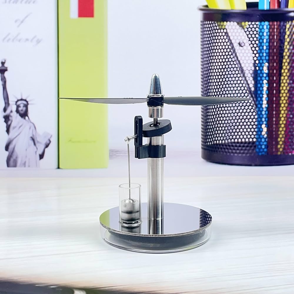 Mini low temperature Stirling engine by Stirling showing metal components and engine mechanism in a close-up view.