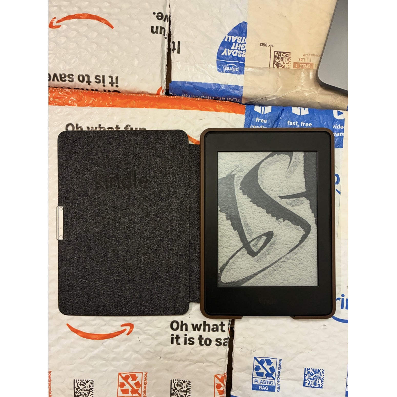 Amazon Kindle PaperWhite 7th generation ebook reader with white front and black back, showing screen display and sleek design.
