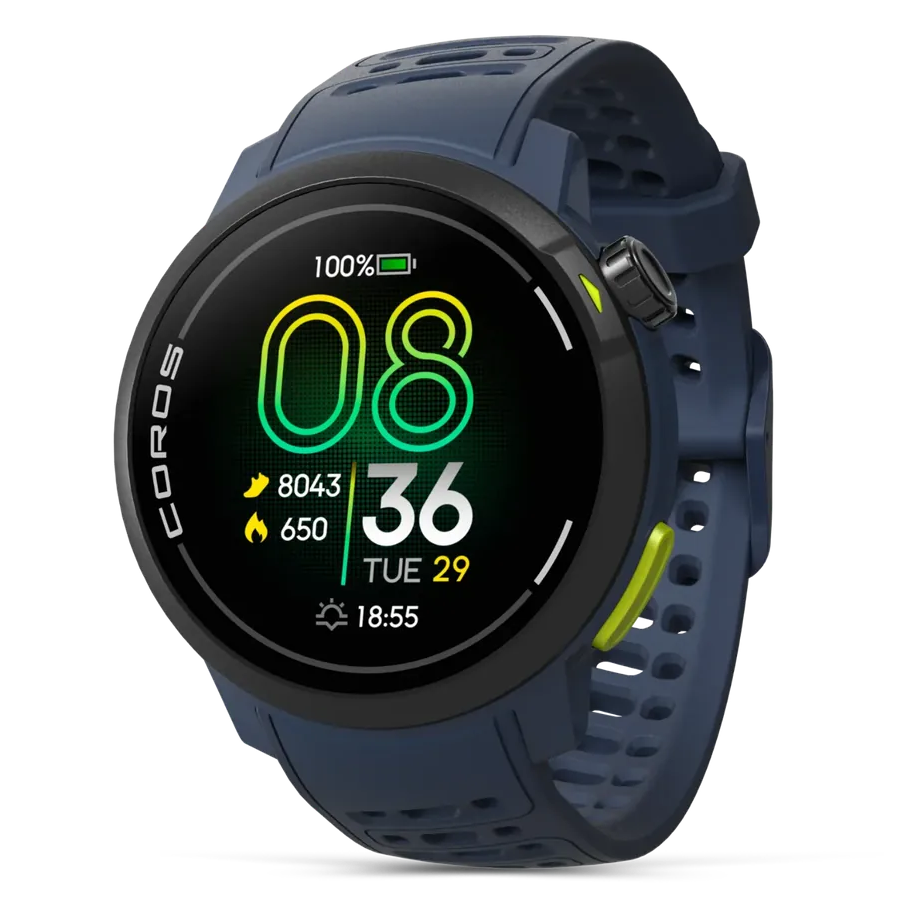 A Coros smartwatch with a dark navy blue silicone strap and a black round case, featuring a digital watch face with green and yellow elements, shown on a solid white background.