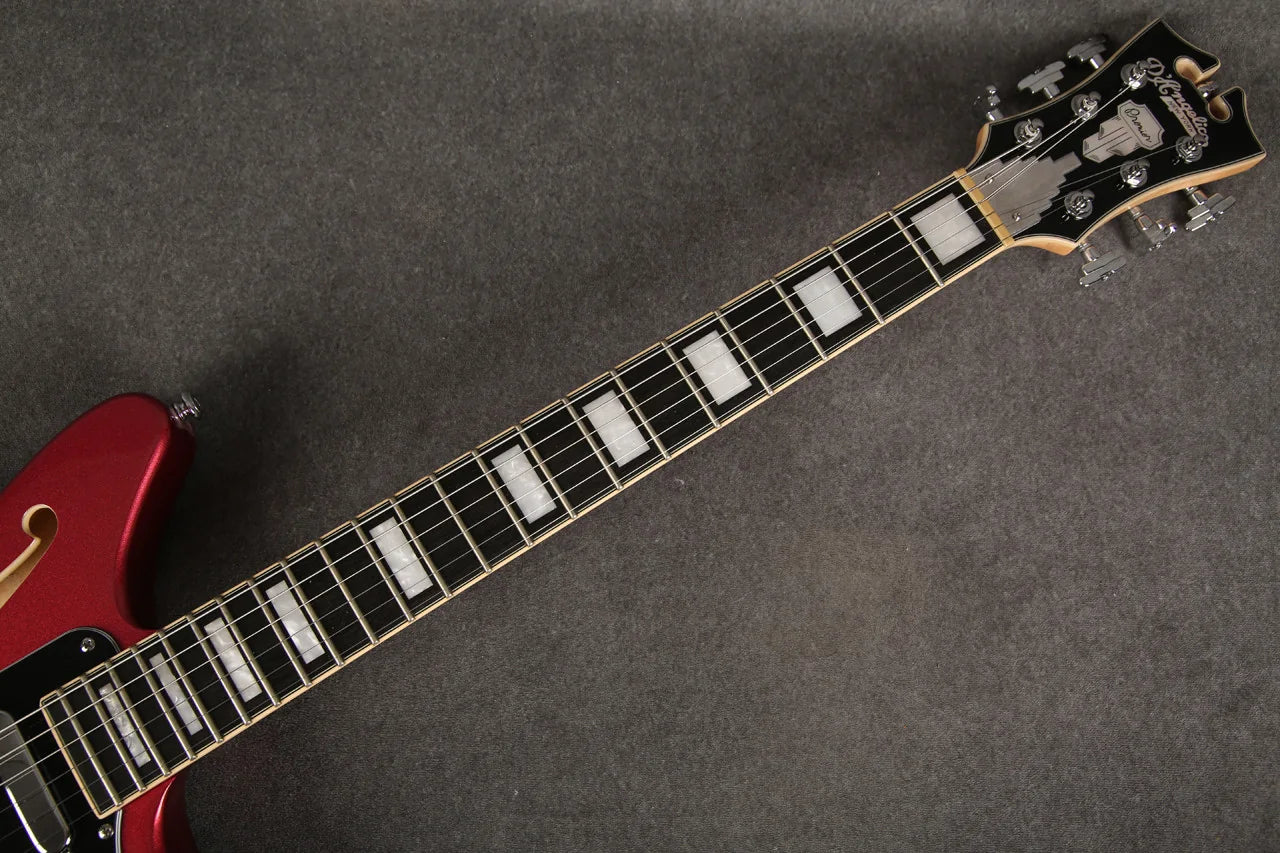 D'Angelico Premier Bedford guitar with oxblood red finish, showing the fretboard and headstock in a close-up image.