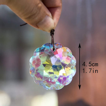 VOT Certified crystal suncatcher with Datura-shaped prisms hanging in sunlight, creating colorful light reflections.