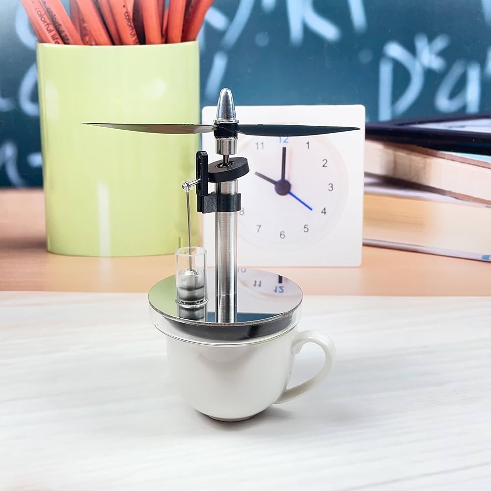 Mini low temperature Stirling engine by Stirling showing metal components and compact design on a white background.