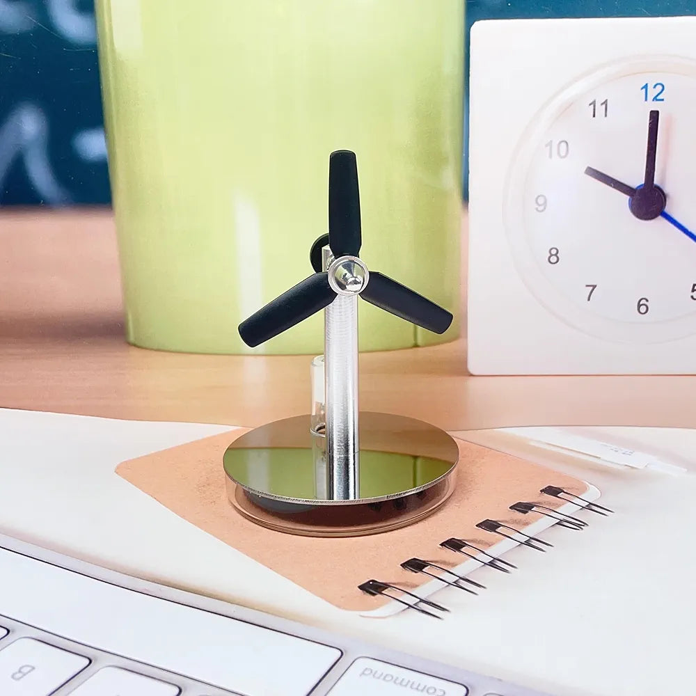 Mini Stirling low temperature engine by Stirling showing metal components and small size on a white background.