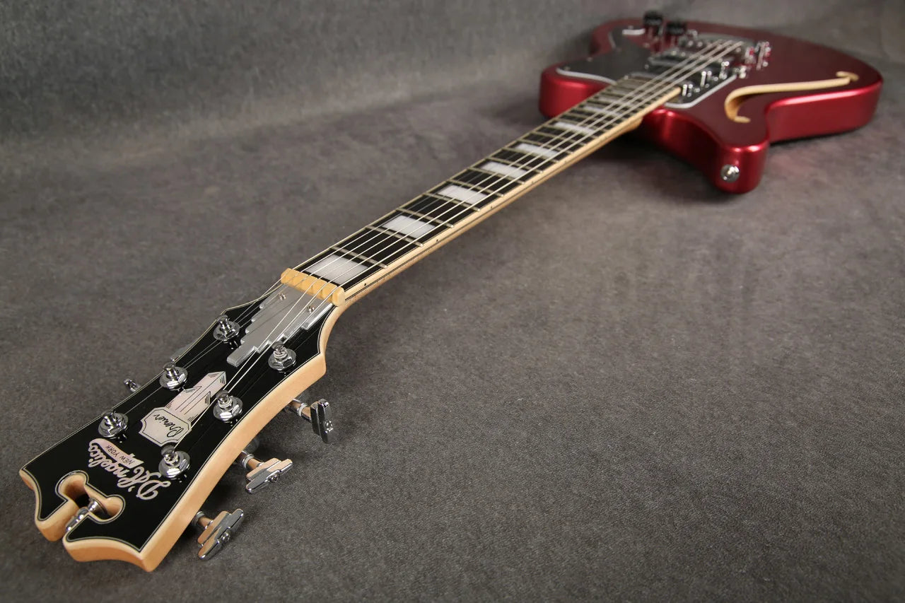 D'Angelico Premier Bedford guitar in oxblood red, showing full-angle view of the electric guitar with sleek design and hardware.