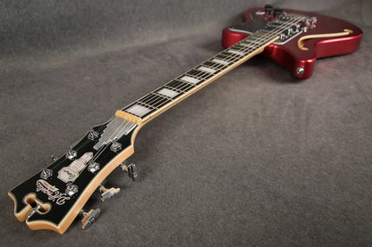 D'Angelico Premier Bedford guitar in oxblood red, showing full-angle view of the electric guitar with sleek design and hardware.