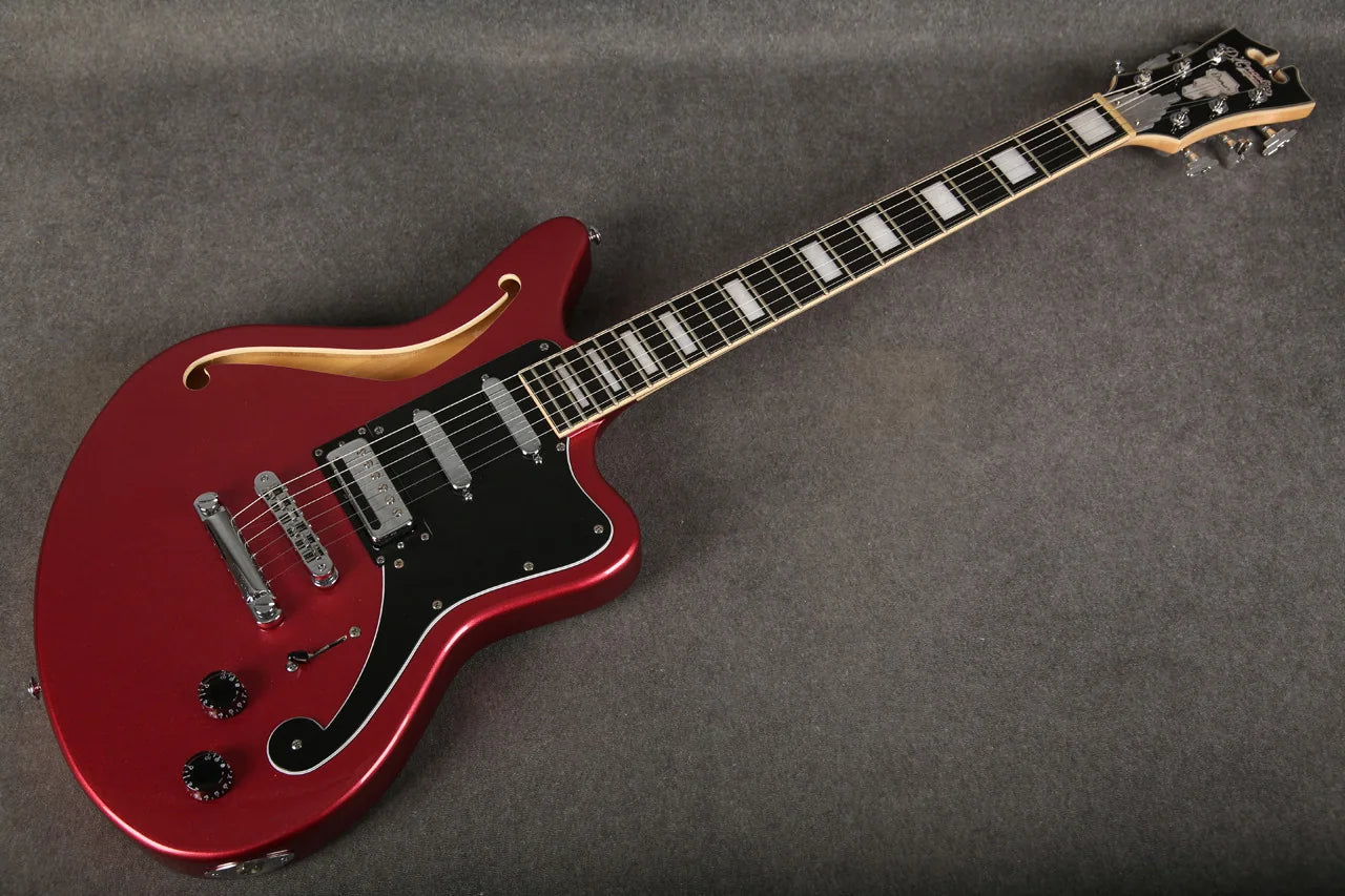 Close-up of the neck joint on a D'Angelico Premier Bedford guitar in oxblood red, showing detailed craftsmanship and finish.