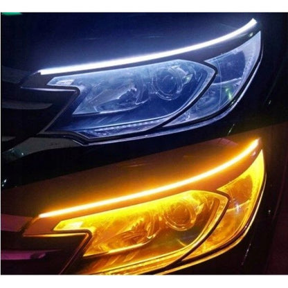 Close-up of a car's headlight and turn signal with a dark background