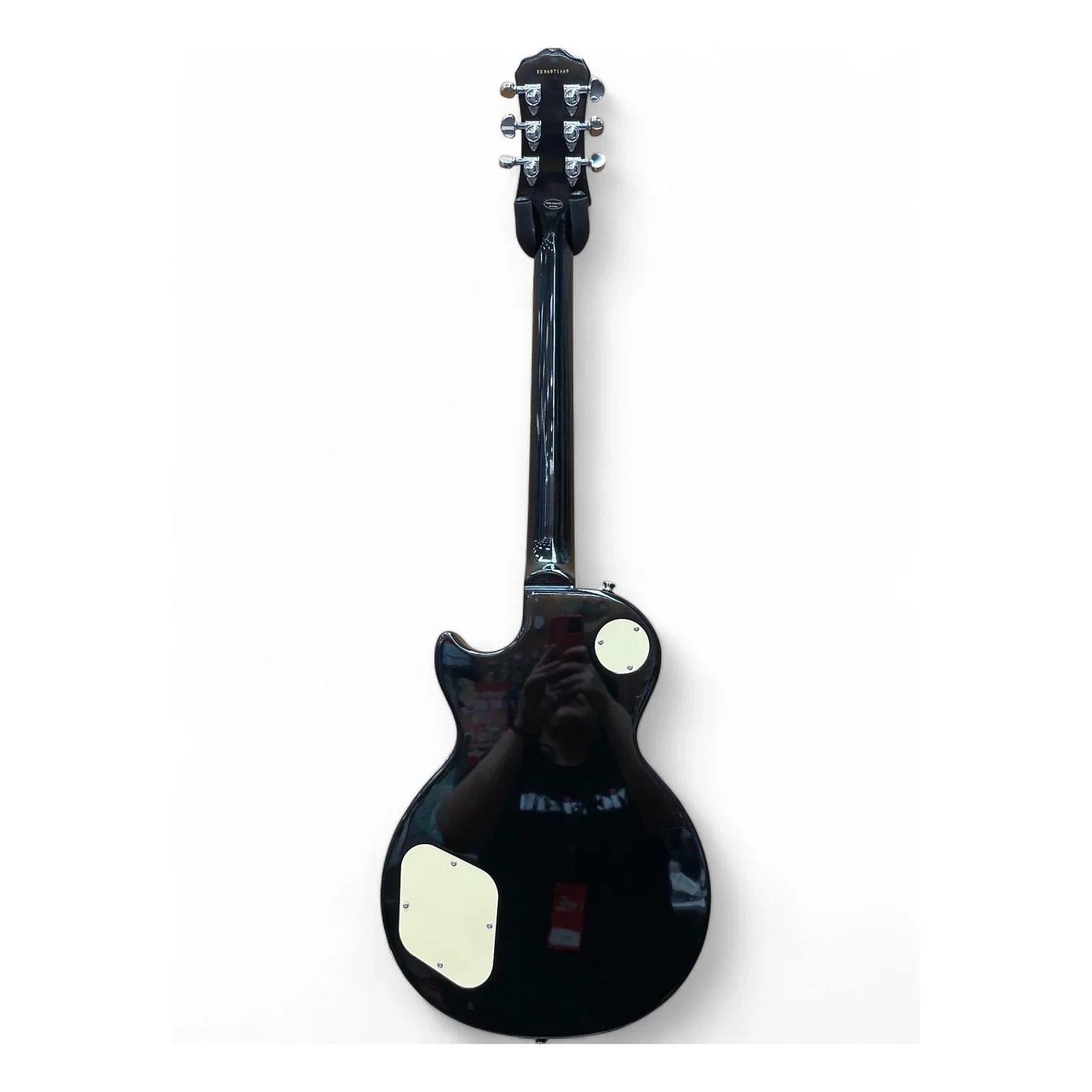 Black electric guitar on a white background