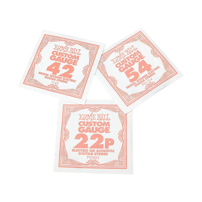 Three Ernie Ball Custom Gauge guitar string packets in different gauges (42, 54, and 22P) arranged on a plain white background.