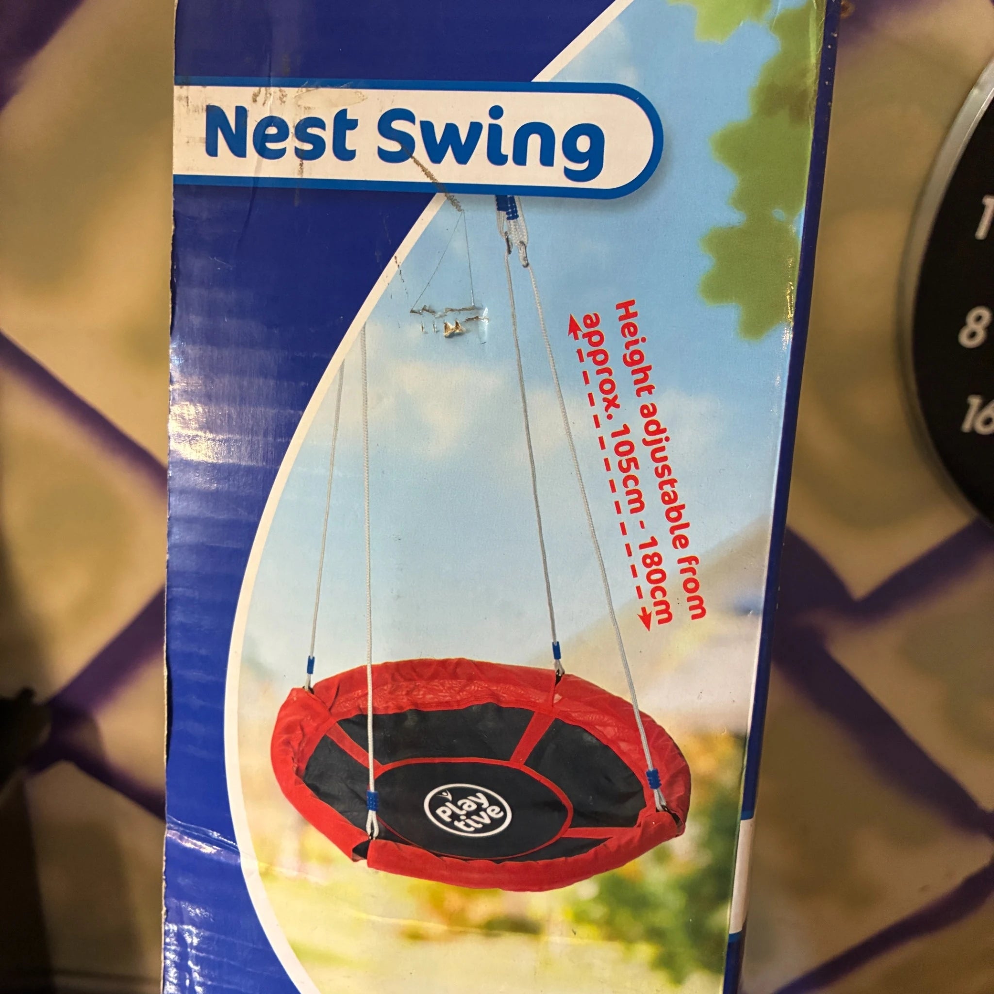 Box of a Nest Swing with a red and black swing on the label.