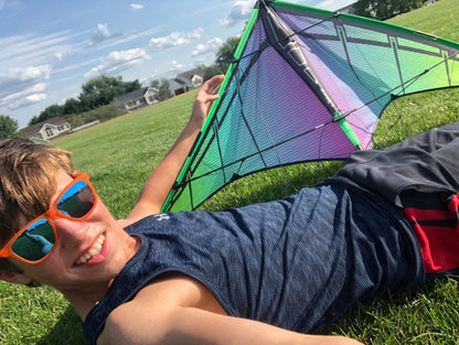 Prism Jazz 2.0 Dual-line Sports Kite flying outdoors, showcasing vibrant colors and aerodynamic design in the sky.