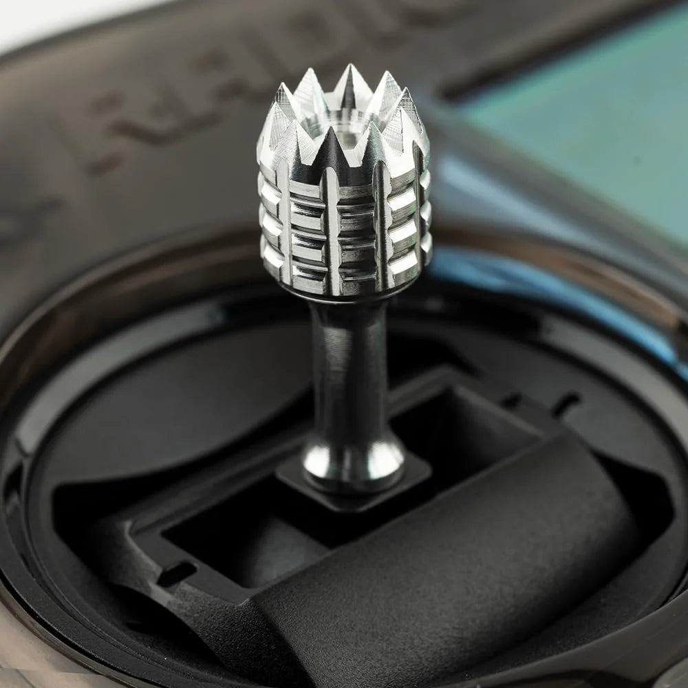 Close-up of a car gear shift lever with a detailed design.