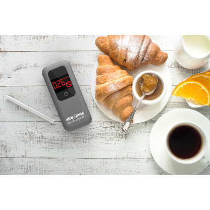 White AlcoSense SE2 alcohol breathalyzer appliance displayed on a breakfast table, showcasing its compact design and digital screen.