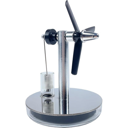 Mini Stirling low temperature steam engine by Stirling showing a small metal engine with moving parts and steam inlet in a close-up view.