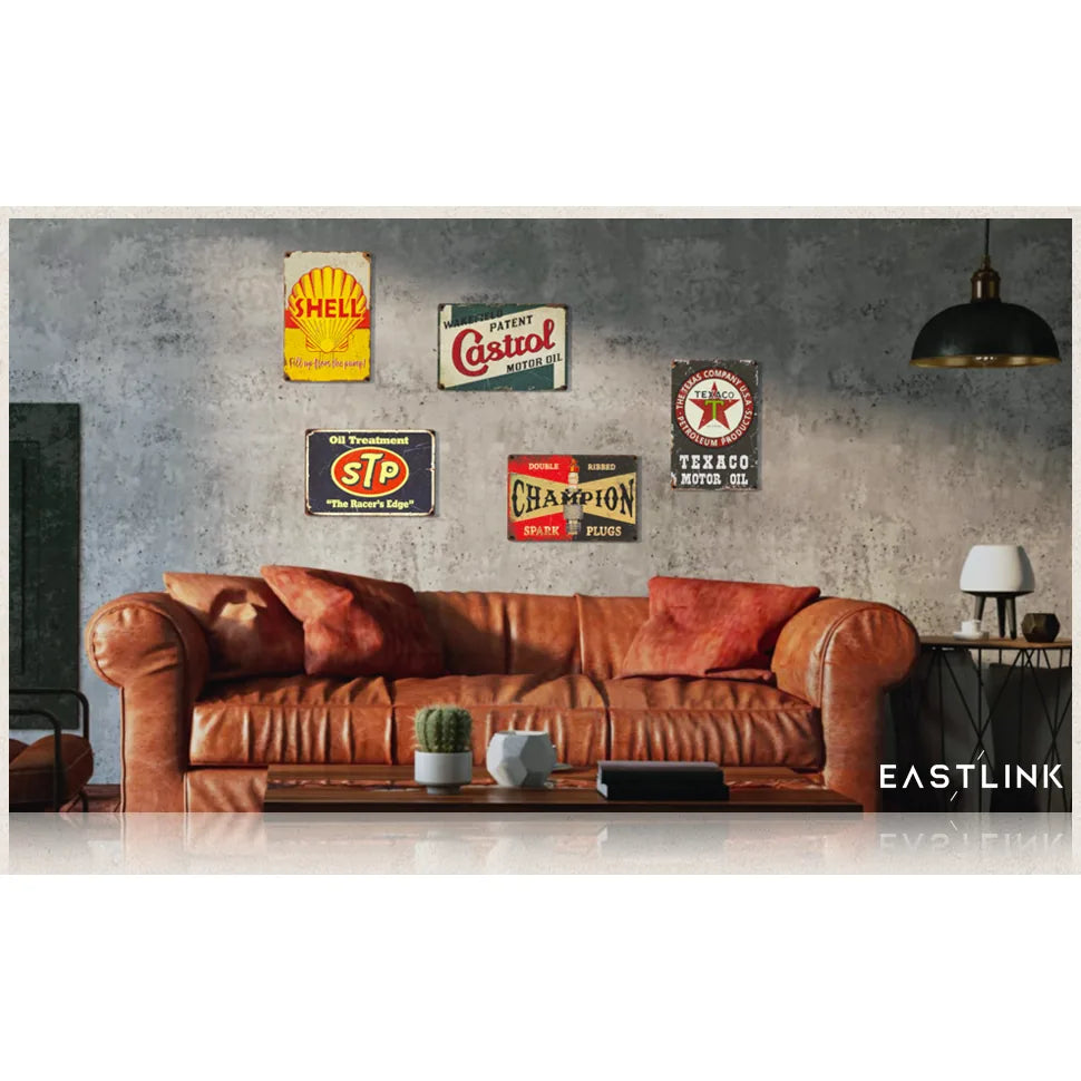 Set of 5 vintage tin double-sided PVC garage signs displayed on a living room wall, featuring classic oil-themed designs.